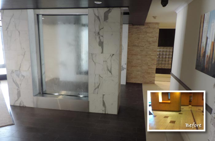 Refurbished building lobby with marble-clad columns, a glass water feature and dark tile floor; inset shows the dated lobby before the work